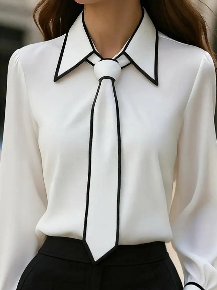 Blusa elegante con collo annodato e finiture a contrasto